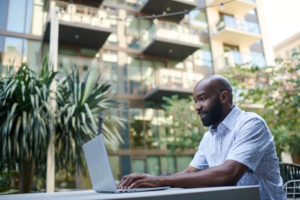 Man using device on courtyard