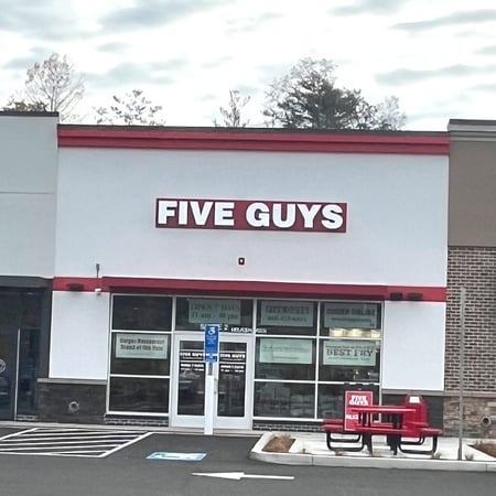 Exterior photograph of the Five Guys restaurant at 106 Storrs Road in Mansfield, Connecticut.