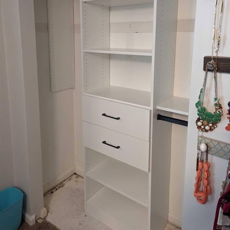 Closet design with shelving, drawers, hanging rods and hangers for jewelry.