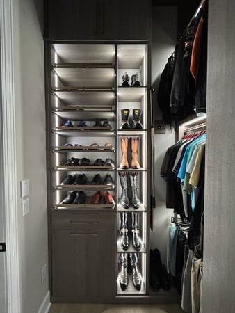 Walk in closet in ash with LED lit shoe shelves and tilt out hamper