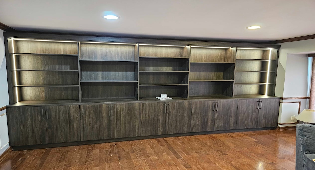 brown woodgrain used in custom, library shelving with integrated lighting