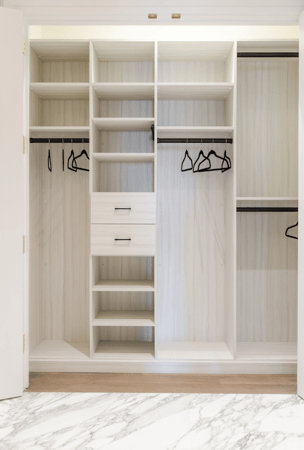 California Closets Manhattan NY White Reach-in Closet with Shelving, Hanging, and Black Hanging Rods