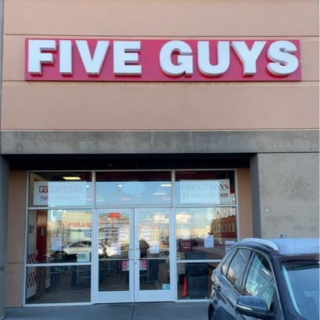Photograph of the entrance to the Five Guys at 10 North Sullivan Road in Spokane, Washington.