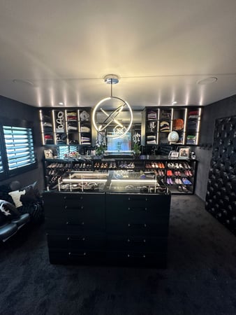 Custom Walk in Closet in Shadow with Lighting and a Glass Top Island