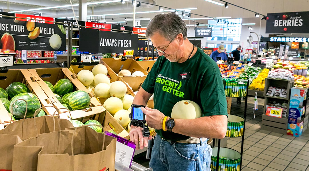 A store associate picking up groceries for an online order