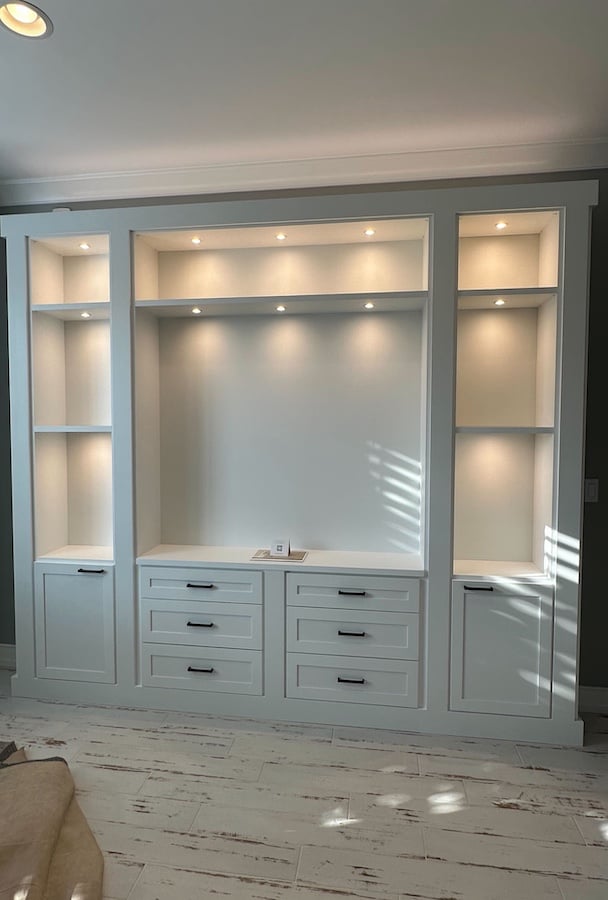Custom white Entertainment center with drawers, doors, and shelves