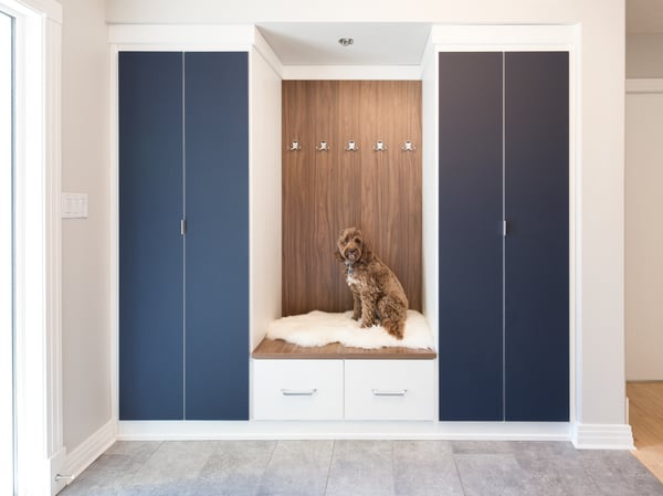 Entry storage with hanging space, drawers, and bench seating by California Closets Calgary, Alberta.