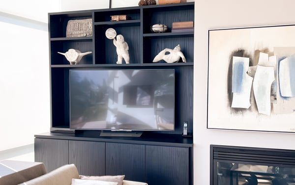 Media unit with open shelves above TV for decor display