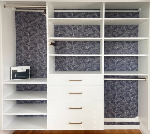 Custom closet shelving and drawers in a white wood grain finish by California Closets Southern New Jersey