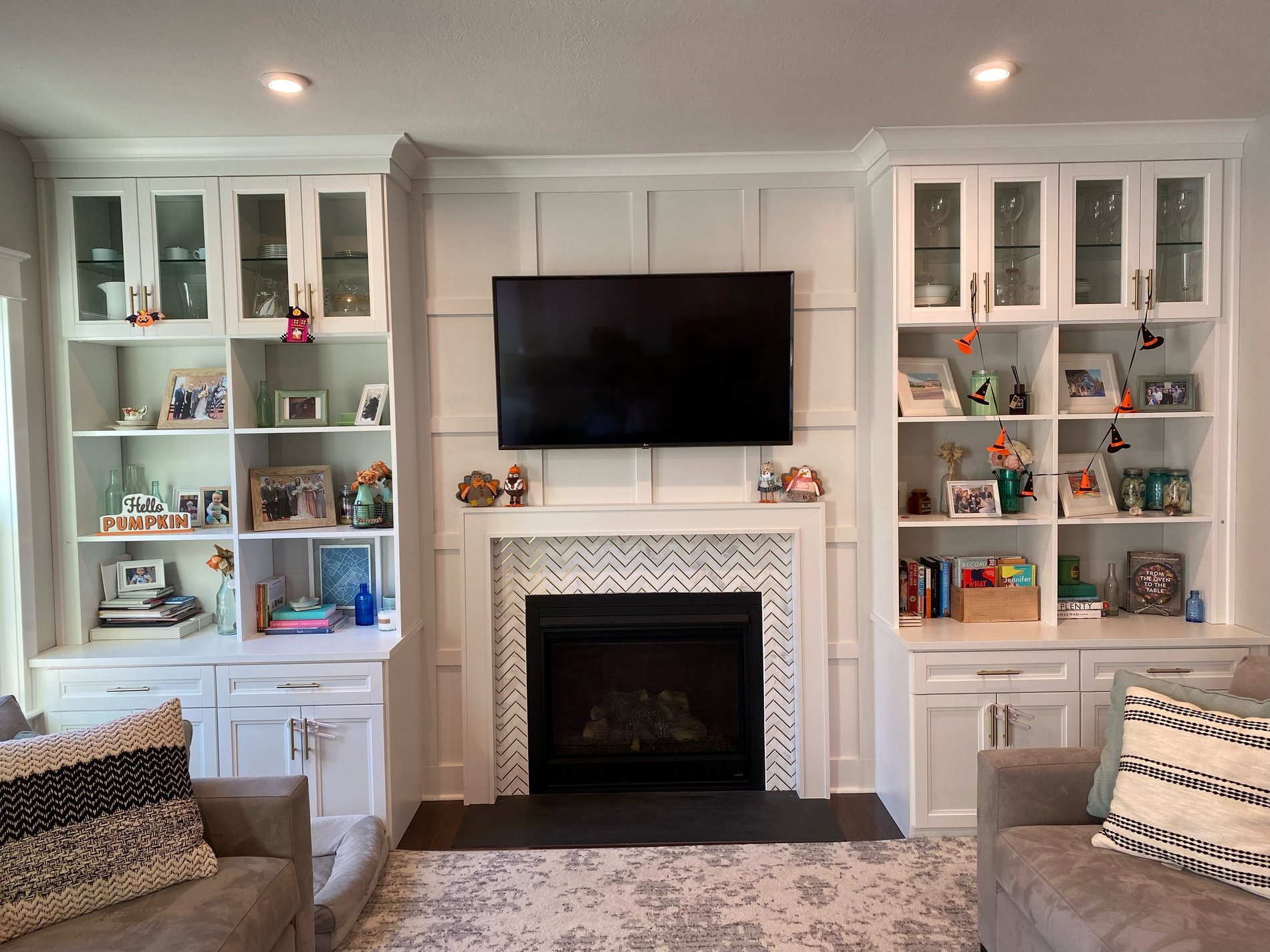Custom Entertainment Center for a living room with a variety of shelving and cabinets on both sides of the system by California Closets Pittsburgh located in Pittsburgh Pennsylvania