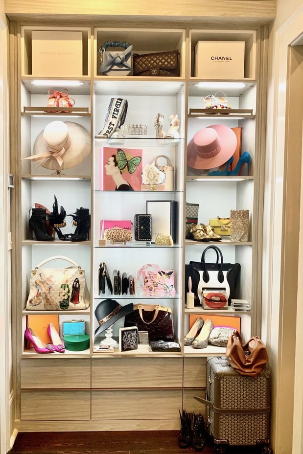 Reach in closet organization with glass shelving and lights for closets California Closets Gulf Coast & New Orleans