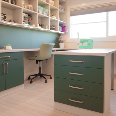Craft room in a mushroom color with dark green backing and doors and drawer fronts.