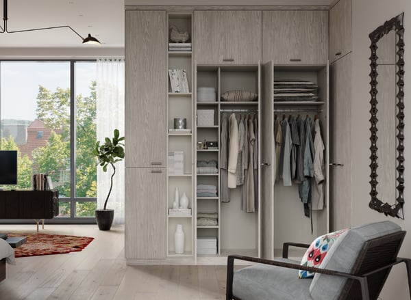 Custom Luxury Corner wardrobe with light grey woodgrain door and drawer fronts and inset areas with collectables and books, CC Wood Grain™ finish in Grigio, Box-in-a-box accent counter area in CC Specialty™ finish Linen