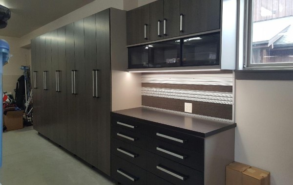 Garage storage with work bench, deep storage cabinets, and lighting