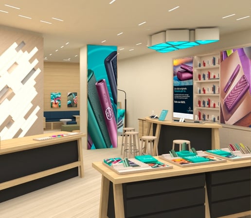 Immagine IQOS store con dispositivi a tabacco riscaldato su due tavoli di legno