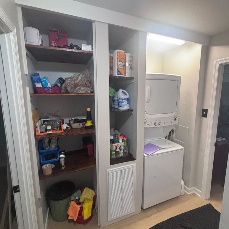 Richmond - Custom closets - laundry area with open shelving, storage cubbies, and a stacked washer and dryer unit