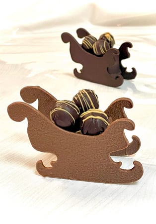 Traineaux en chocolat avec petites truffes à la clémentine