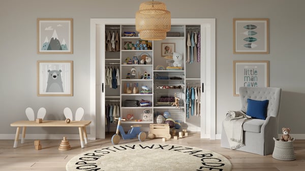 White finish reach-in nursery closet with baskets and multi-level hanging by California Closets Greenwich, Connecticut.