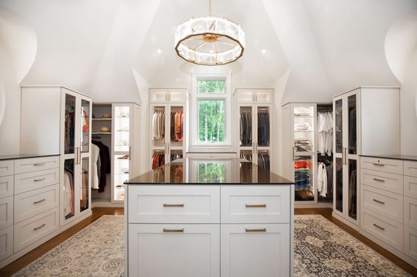 Attic Space Converted to Custom Dressing Room with Accent Lighting, Glass Doors and Shoe Shelves, Key-Lock Drawers, and Island with Tilt-Out Hampers for Laundry in Malvern, PA