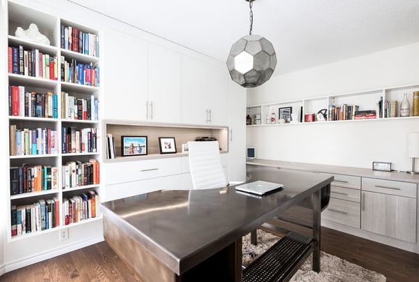 Custom home office with bookshelves and cabinetry by California Closets Edmonton, Alberta.