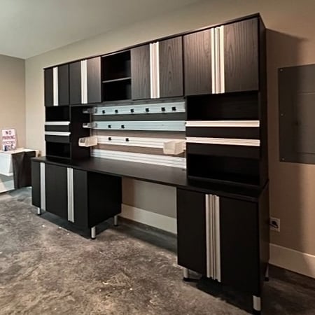 Black and silver garage storage cabinets with a work bench California Closets Gulfport & Hattiesburg, Diamondhead, MS
