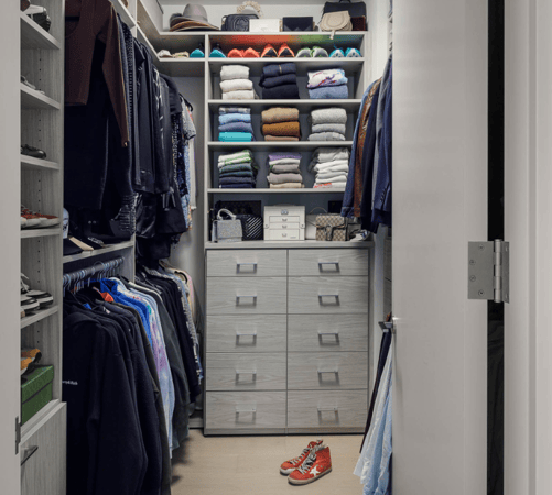 gray walk-in closet his & her closet with double hanging, shelving for color coded sweaters, and drawers Brooklyn New York