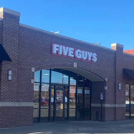 Exterior photograph of the Five Guys restaurant at 1025 East Douglas Avenue in Wichita, Kansas.