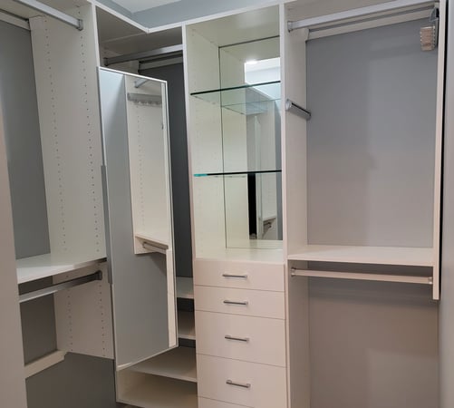 White walk-in closet with a pull-out mirror