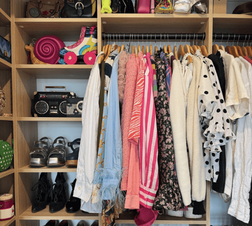 California Closets New York wood custom reach in closet with custom adjustable shelving for folding shoe organization or accessories overhead shelving double hanging rods for hanging clothes