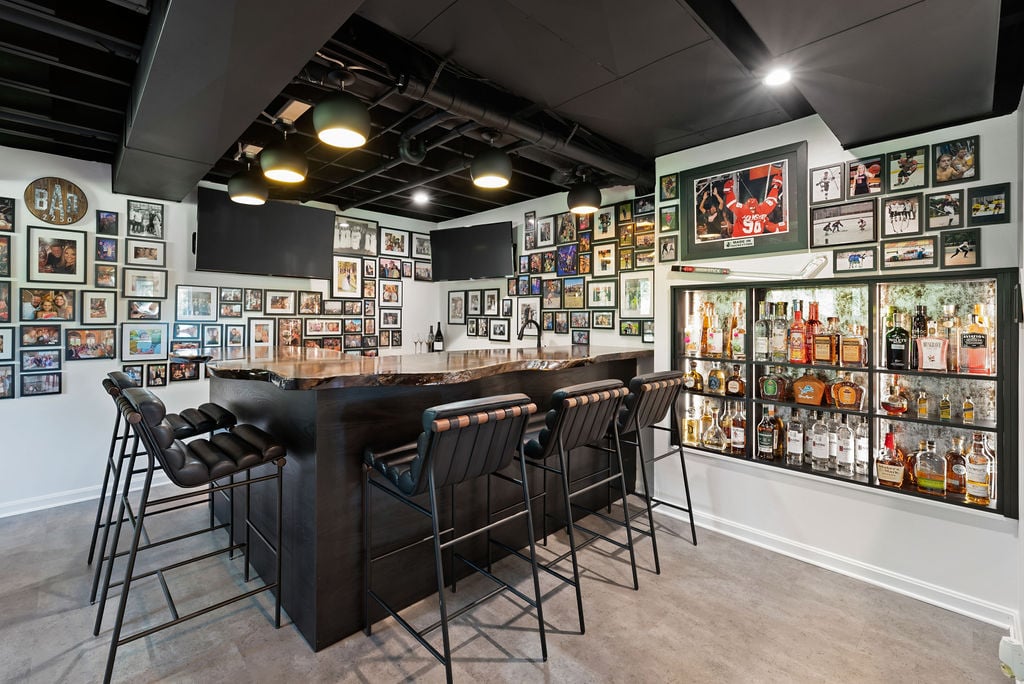 Custom Bar with photos, glass backsplash, and L-shaped bar