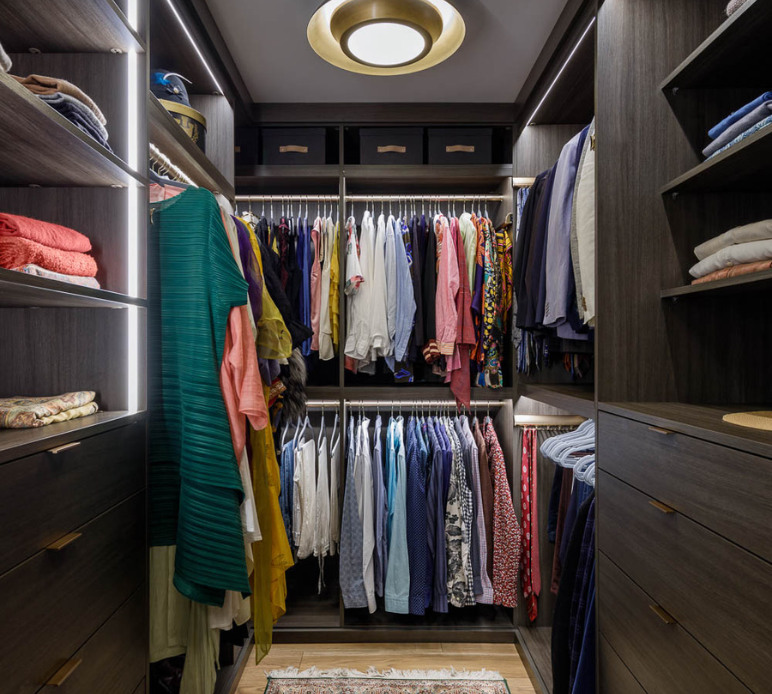 brown walkin custom closet with hanging shelving LED lighting and drawers