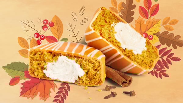 A Pumpkin Spice No Name Cake from MOD Pizza is split in half and surrounded by fall colors and leaves