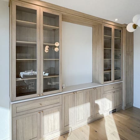 Dining room with upgraded storage. Glass doors help to break up the solid doors on the lower cabinetry and allow the perfect place to display special items.