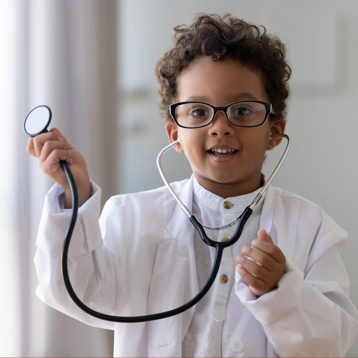 Child with doctor coat and stethoscope.
