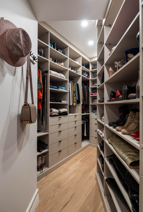 beige custom walk-in closet with glass doors, hanging, shelving, shoe wall, tilt-out hampers, hanging hooks Manhattan NY