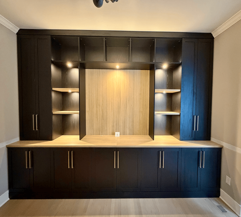 Custom wall units with integrated lighting, shelving, and cabinets