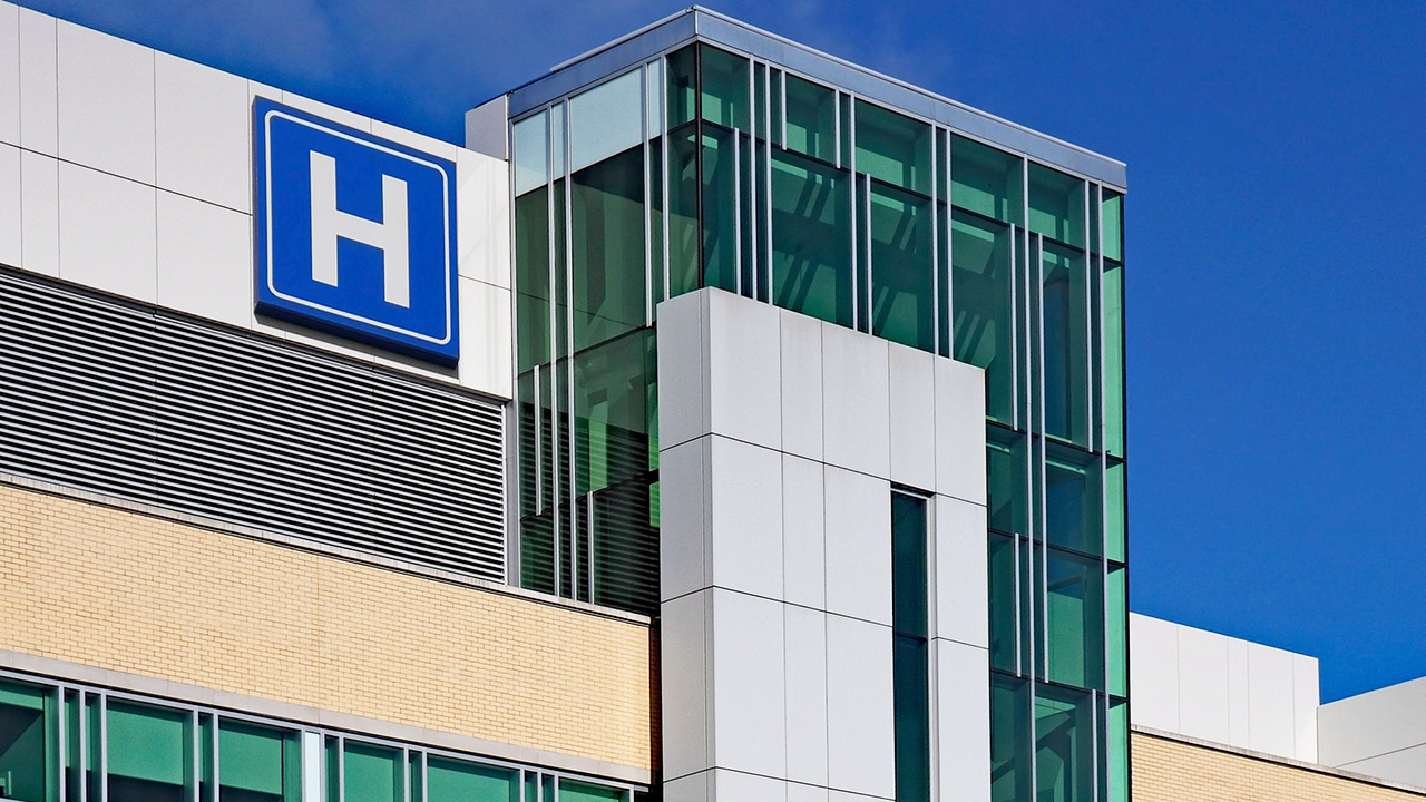 Hospital facade with a large H logo