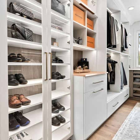 Walk in closet with shoe shelves, vanity, and double hang by California Closets Northern Michigan