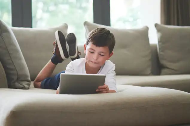 Child on tablet using home internet services