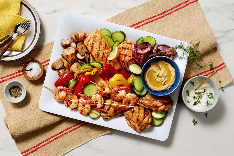 grilled chicken shrimp and sides on a platter