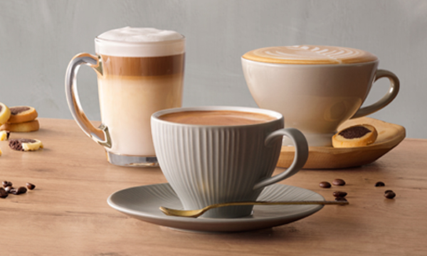 Caffe Latte, cappuccino and Americano coffee drinks on a wooden table.