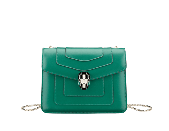 “Serpenti Forever” crossbody bag in emerald-green calfskin with amethyst-purple grosgrain inner lining. Iconic snakehead closure in light gold-plated brass embellished with black and agate-white enamel and green malachite eyes.