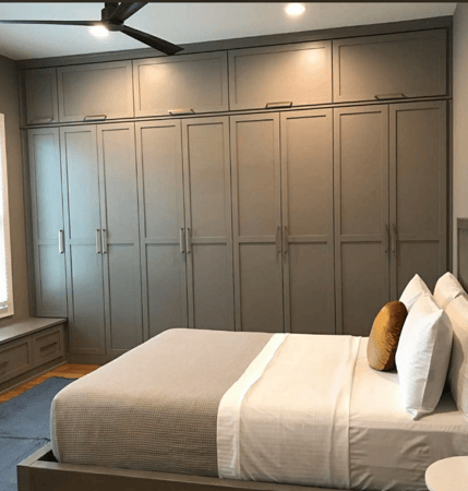 Gray flushed storage cabinets across side wall