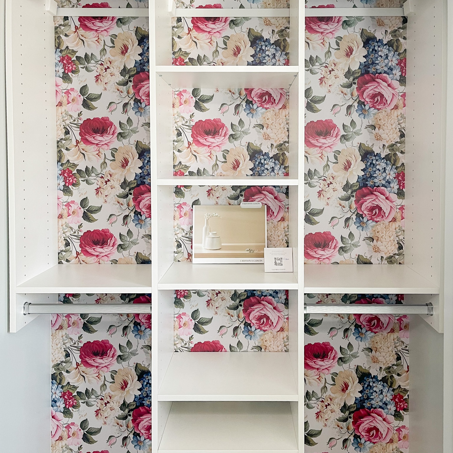 Simple reach-in closet with double hang and open shelving in the centre.