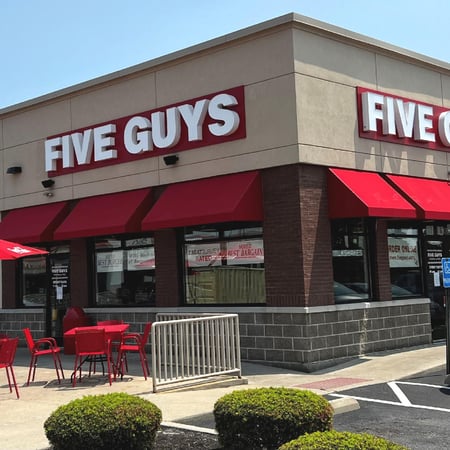 Exterior photograph of the entrance to the Five Guys restaurant at 7668 Mall Road in Florence, Kentucky.