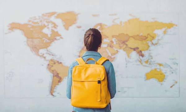 地図を眺めるリュックショックを背負った人物