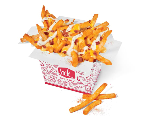 Yes, our French fries are already awesome, but we decided to reinvent the wheel and sprinkle on some extra-delicious nacho flavor to them. Once the fries are seasoned up, let the saucing and loading of cheddar cheese sauce, bacon pieces, ranch, and shredded cheddar commence!