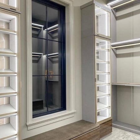 Walk-in closet with lighting and custom shoe organization California Closets New Orleans & Gulf Coast