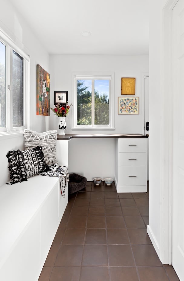 a mudroom featuring space for your pet, glass doors, and drawers with a bench