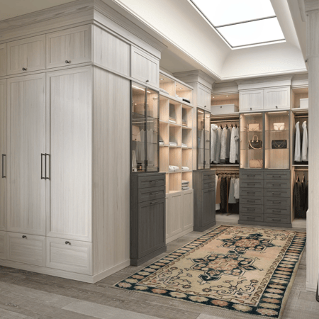 Custom wardrobe with floor-to-ceiling storage, drawers, shelving, hanging space, and integrated lighting.